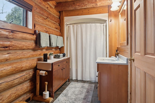 bathroom with vanity and beam ceiling