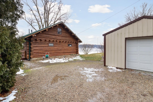 exterior space featuring a garage and an outdoor structure