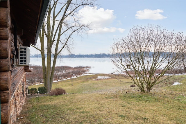 view of yard with a water view and ac unit