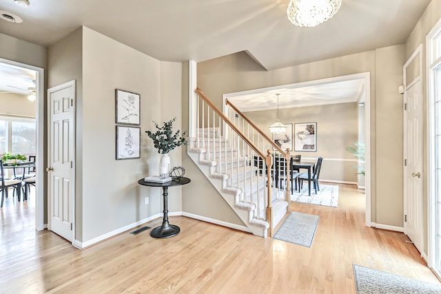 foyer featuring hardwood / wood-style flooring and an inviting chandelier