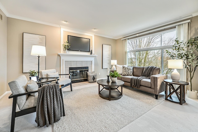 living room with ornamental molding and a fireplace