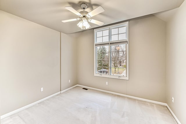 empty room with light colored carpet and ceiling fan