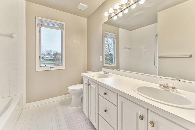 bathroom featuring vanity, toilet, and tile patterned flooring