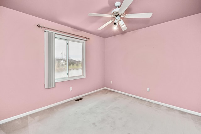 empty room featuring carpet flooring and ceiling fan