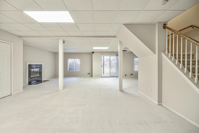 basement with light carpet and a drop ceiling