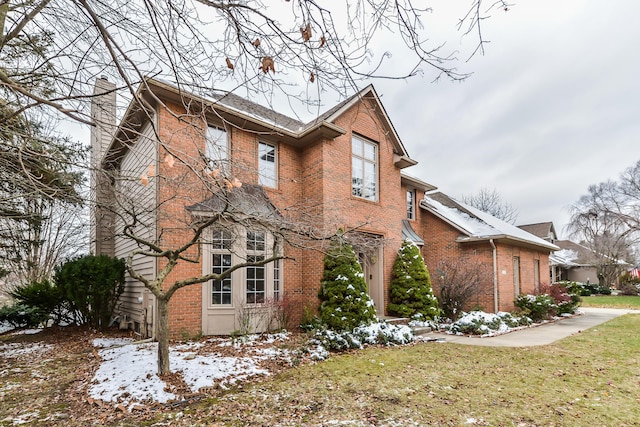 snow covered property featuring a lawn