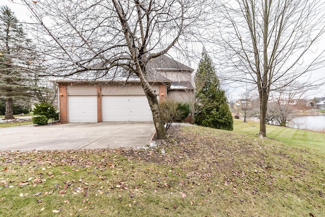 view of side of property featuring a garage and a water view