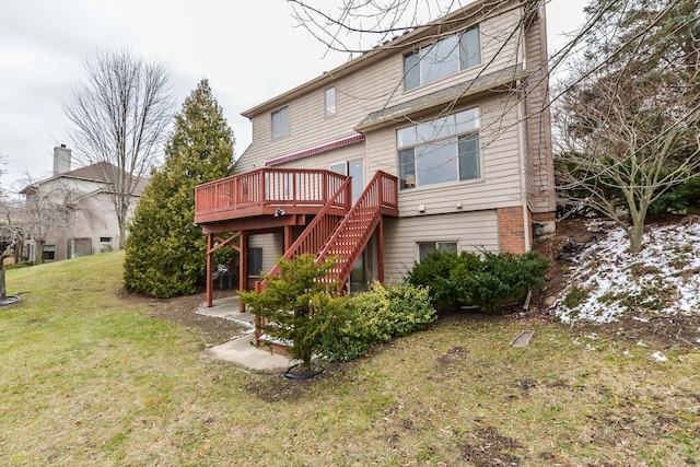 back of property featuring a wooden deck and a yard