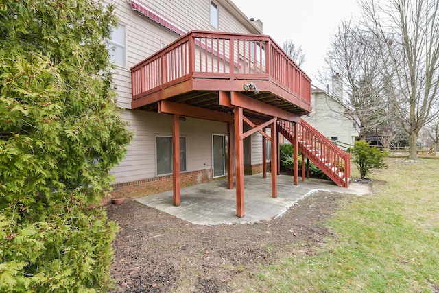 exterior space with a deck, a patio area, and a lawn