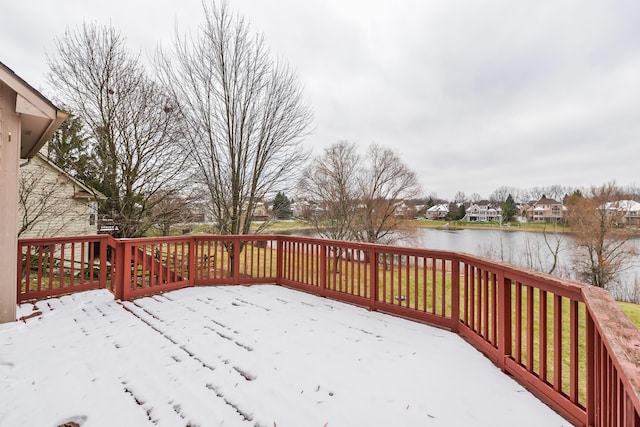 snow covered deck featuring a water view