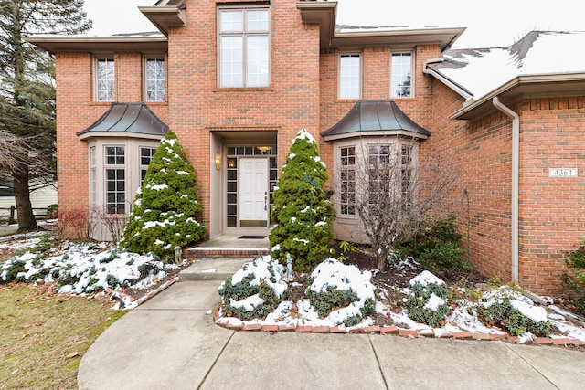 view of snow covered property entrance