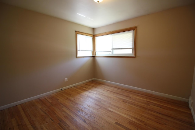 spare room with hardwood / wood-style floors