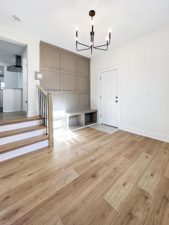 unfurnished dining area with light hardwood / wood-style floors and a chandelier