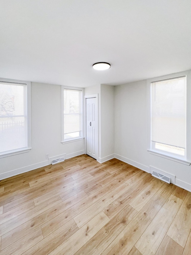 spare room featuring light hardwood / wood-style flooring