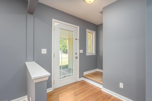 doorway to outside with light wood-type flooring