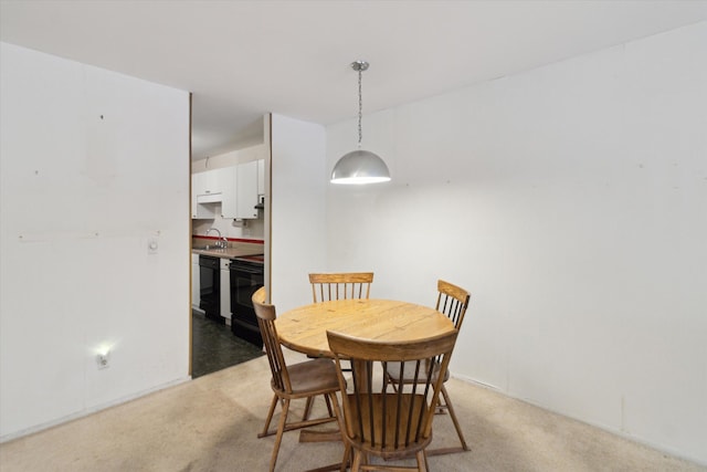 dining area with light colored carpet and sink