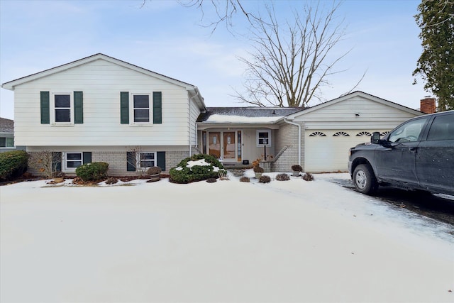 tri-level home with brick siding and an attached garage