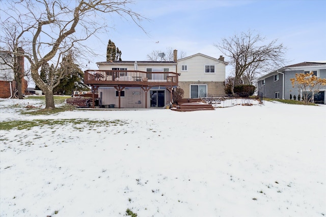 snow covered house with a deck