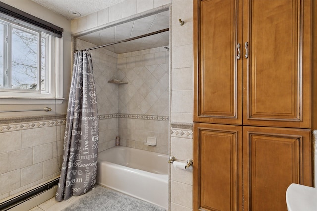 full bathroom featuring tile patterned flooring, a textured ceiling, shower / bath combo with shower curtain, and tile walls