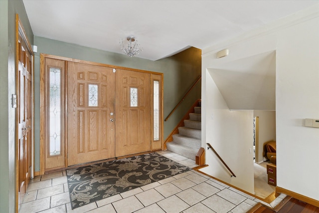 entrance foyer featuring stairs and baseboards