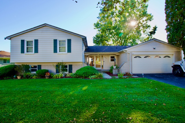 tri-level home with a garage and a front yard