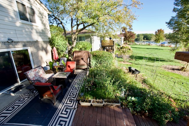 wooden deck with a water view and a yard