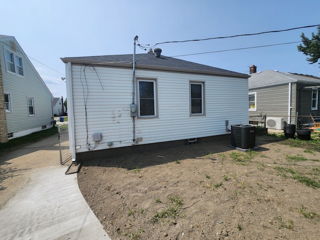 back of property with ac unit and central AC unit