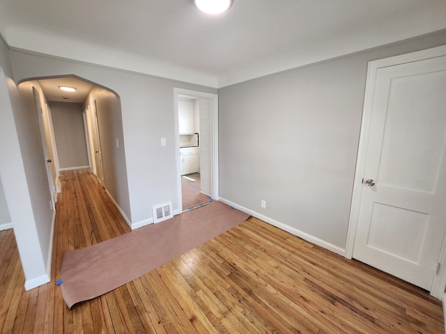 spare room with wood-type flooring