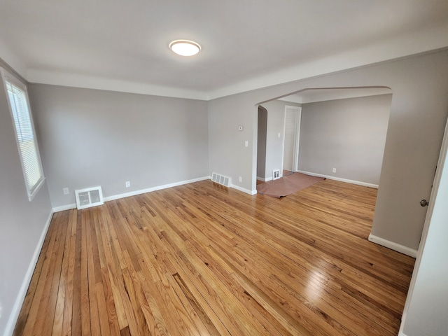 unfurnished room with light wood-type flooring