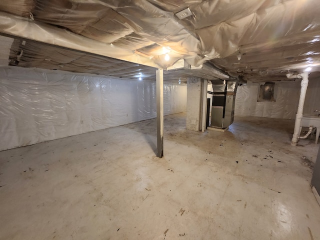 basement with heating unit and electric panel