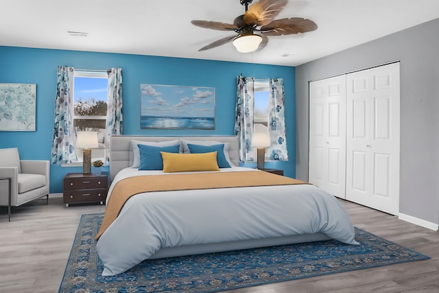 bedroom featuring hardwood / wood-style flooring, ceiling fan, and a closet