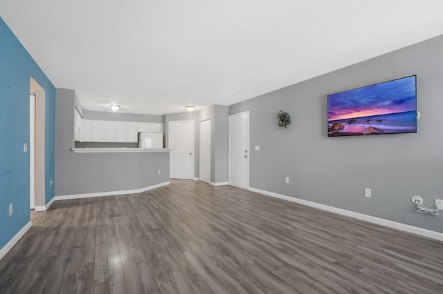 unfurnished living room featuring dark wood-type flooring