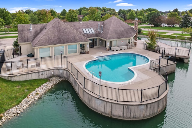 view of swimming pool with a water view and a patio area