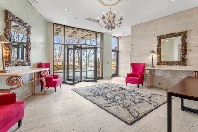 sitting room featuring a wall of windows and a chandelier