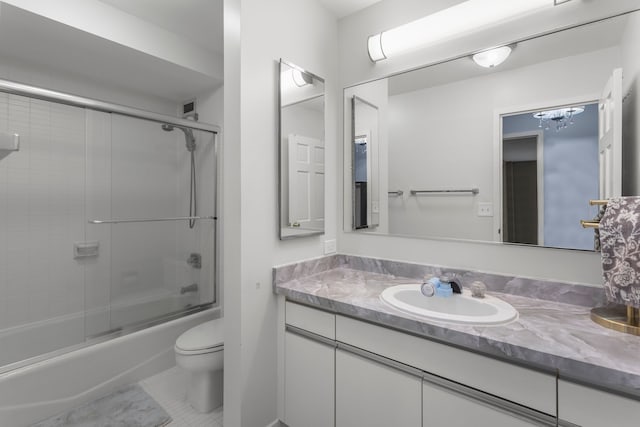 full bathroom featuring toilet, tile patterned floors, vanity, and shower / bath combination with glass door