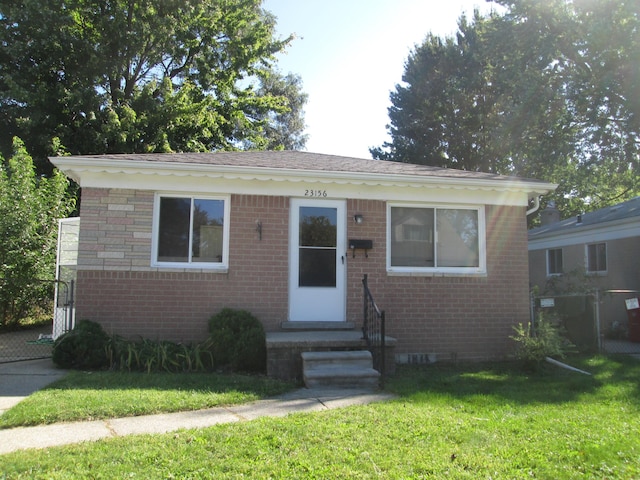 bungalow-style home with a front yard