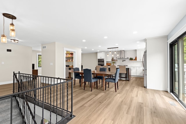 dining space featuring light hardwood / wood-style floors