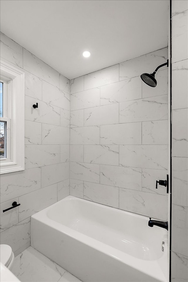 bathroom with shower / washtub combination and toilet