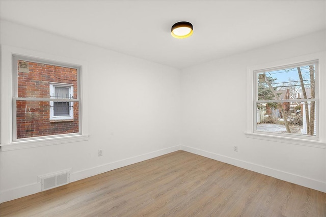 empty room with light hardwood / wood-style flooring