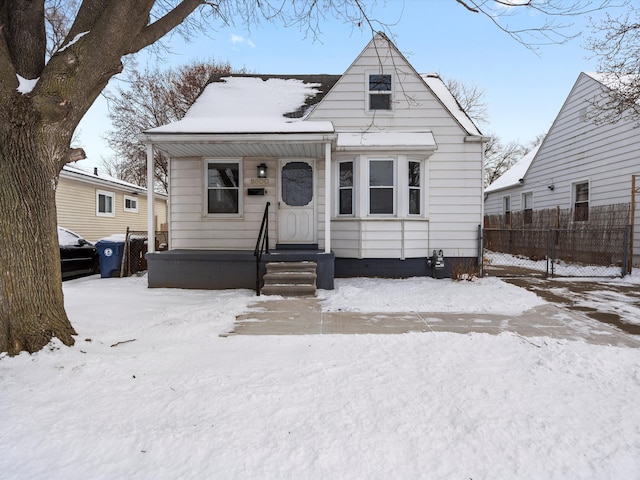 bungalow-style house with fence