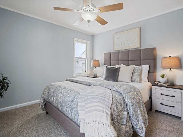 carpeted bedroom with ceiling fan, baseboards, and ornamental molding