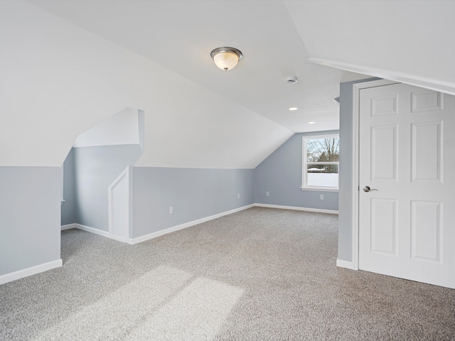 bonus room with carpet flooring, vaulted ceiling, and baseboards