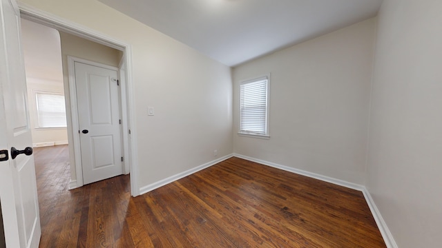 empty room with dark wood-type flooring