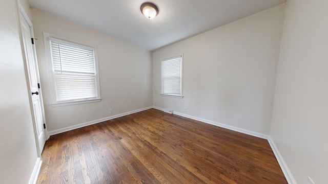 spare room with dark hardwood / wood-style flooring