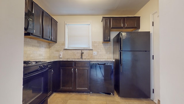 kitchen with light stone counters, dark brown cabinetry, tasteful backsplash, and black appliances