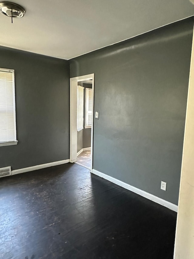 empty room with dark hardwood / wood-style floors