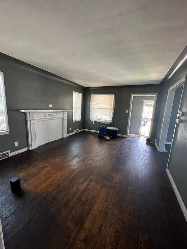 unfurnished living room featuring dark hardwood / wood-style floors