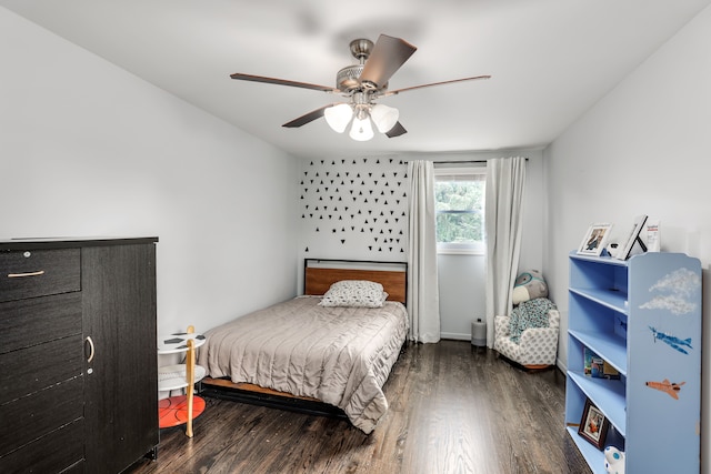 bedroom with dark hardwood / wood-style flooring and ceiling fan