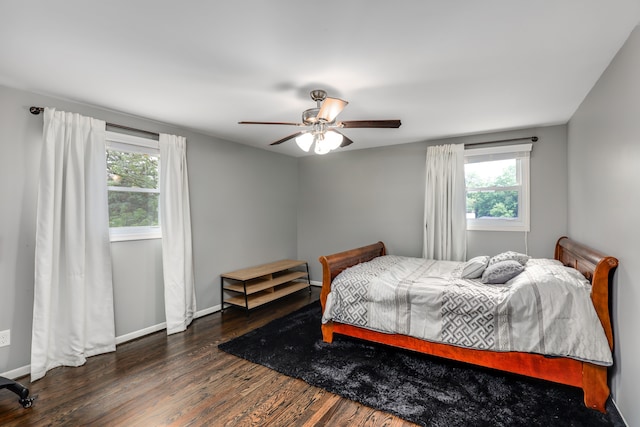 bedroom with ceiling fan and dark hardwood / wood-style floors