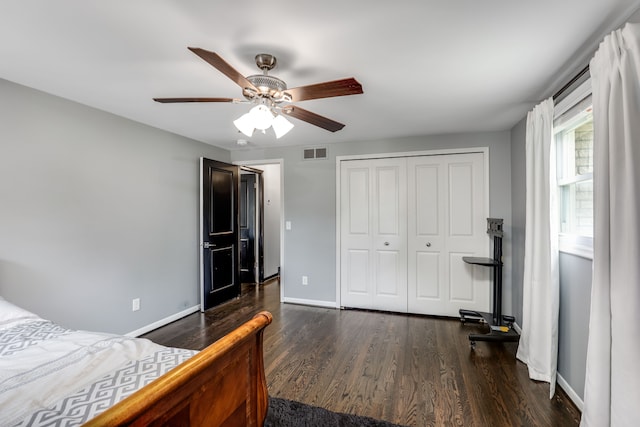 bedroom with ceiling fan, dark hardwood / wood-style floors, and a closet